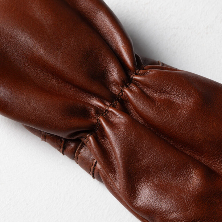 Detailed stitching and full-grain genuine leather texture on golf driver headcover.
