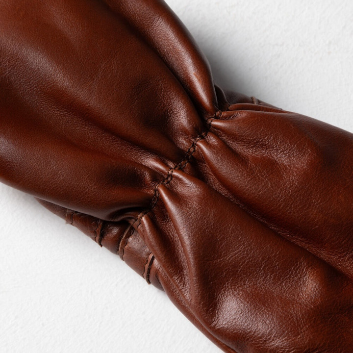 Close-up of padded leather protection and seam stitching on hybrid club headcover.